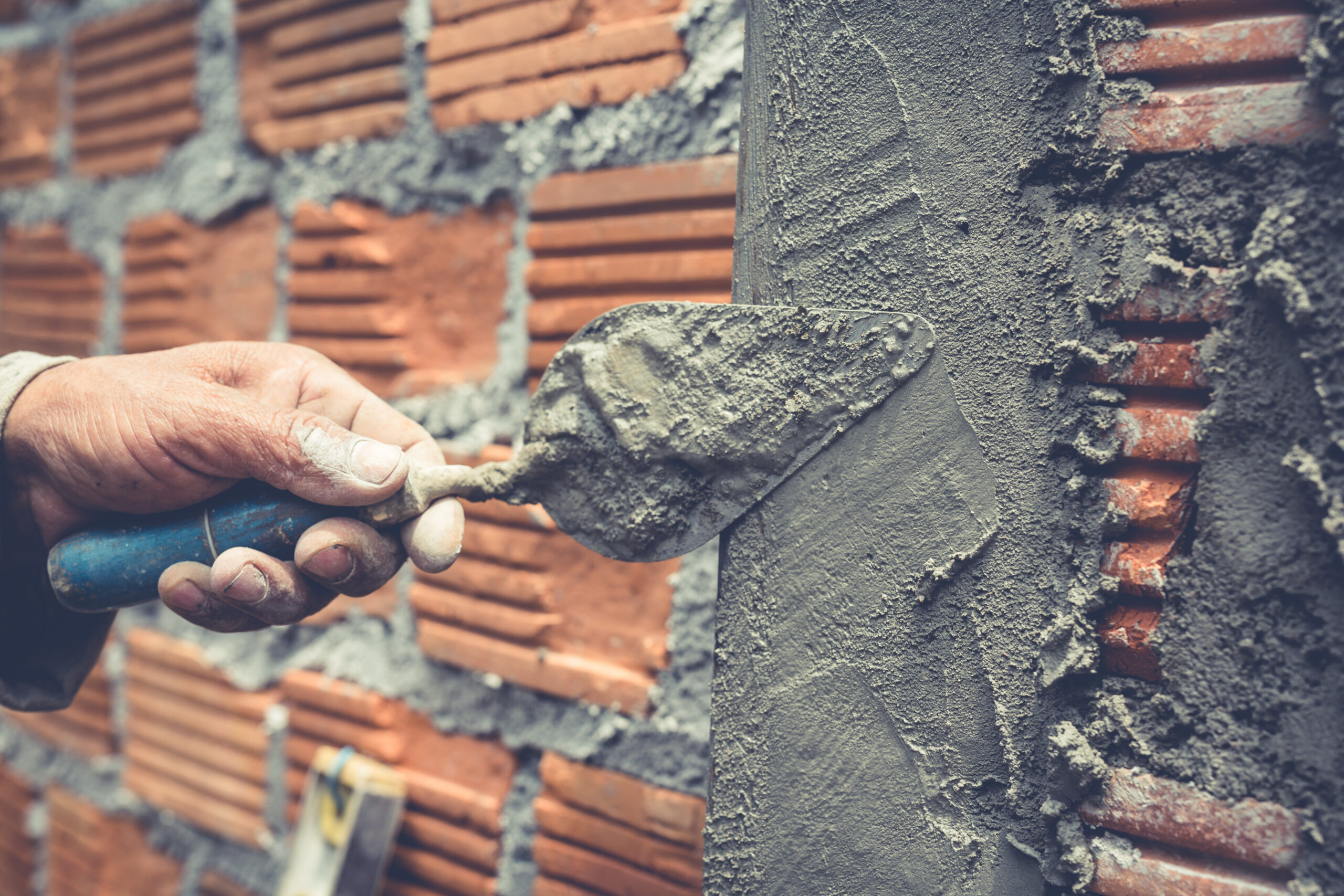 bricklaying. construction worker building a brick wall.