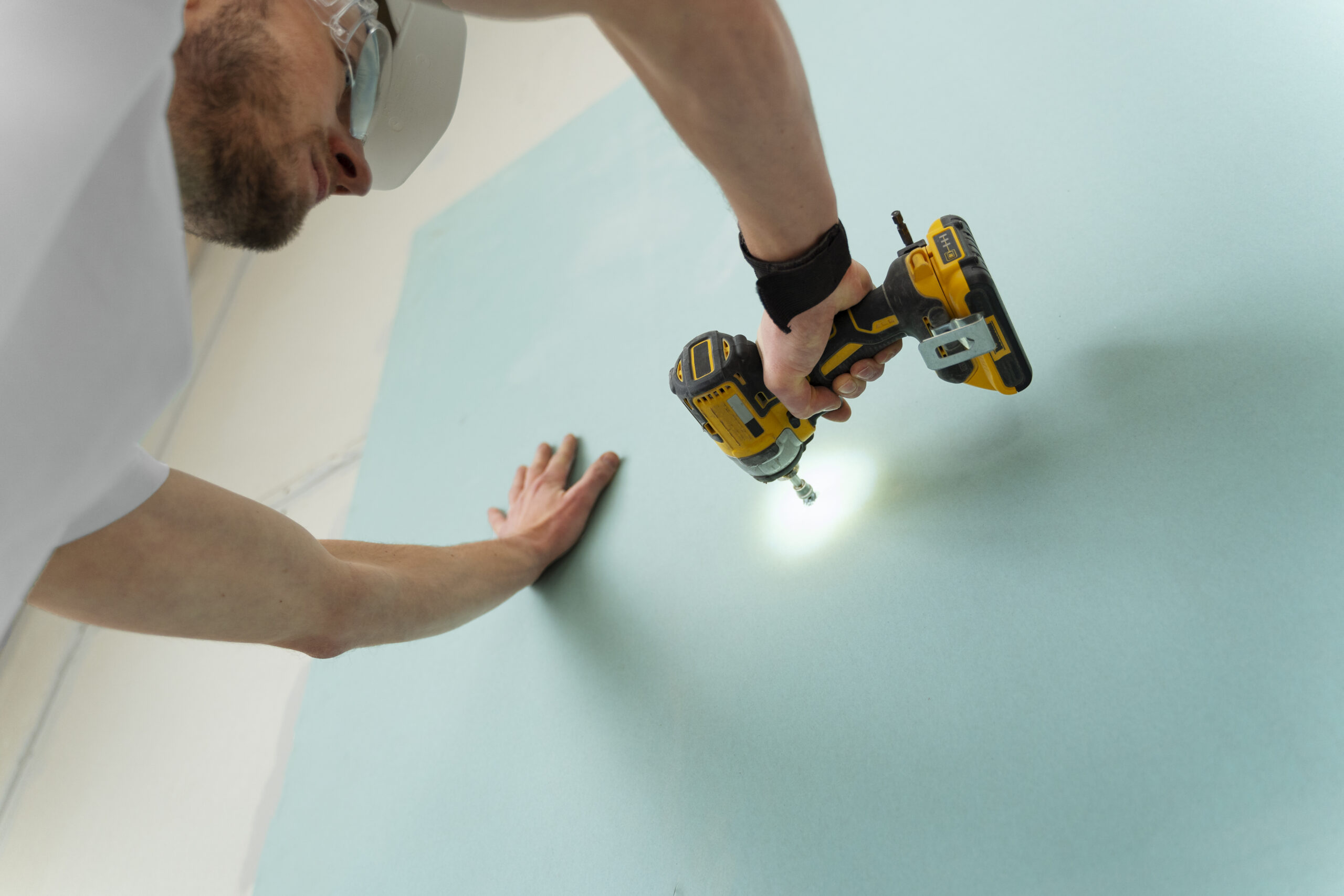 man working with drill low angle